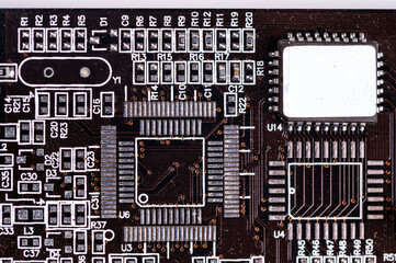 Fototapeta premium macro closeup shot of microchip on black printed circuit board, computer vide ocard with components
