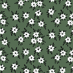 Seamless floral pattern, cute ditsy print with small hand drawn flowers on a dark field. Pretty botanical background with tiny white flowers, dark leaves. Surface graphic design. Vector.