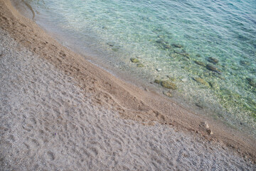 Fototapeta na wymiar Soft blue ocean wave on clean sandy beach, background