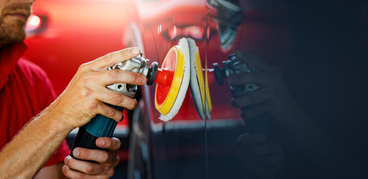 car body repair and detailing workshop. man polishing vehicle paint. copy space