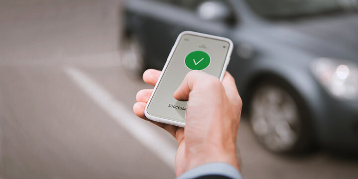 carsharing, transportation and technology concept - close up of hand with on smartphone screen over car on background