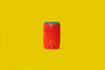Male deodorant on a bright yellow background.