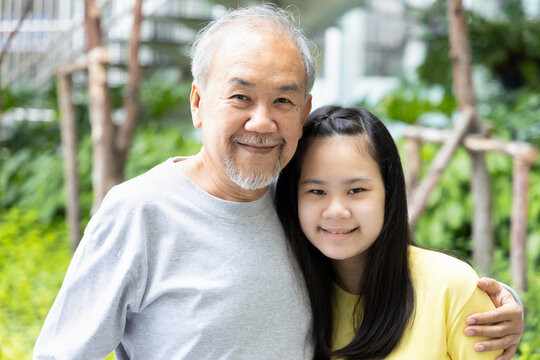 Happy smiling daughter with late married senior father or niece with old aging grandfather