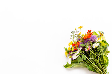 Bunch of wild meadow flowers and herbs chamomile, cornflower and ranunculus. Summer floral background
