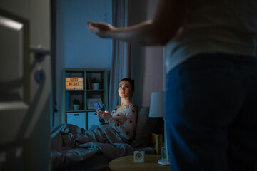 technology, bedtime and people concept - teenage girl with tablet pc computer sitting in bed at...