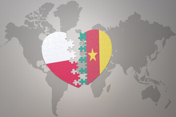 puzzle heart with the national flag of cameroon and poland on a world map background.Concept.