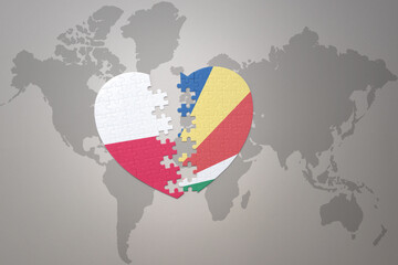 puzzle heart with the national flag of seychelles and poland on a world map background.Concept.