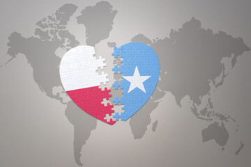 puzzle heart with the national flag of somalia and poland on a world map background.Concept.