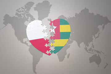 puzzle heart with the national flag of togo and poland on a world map background.Concept.