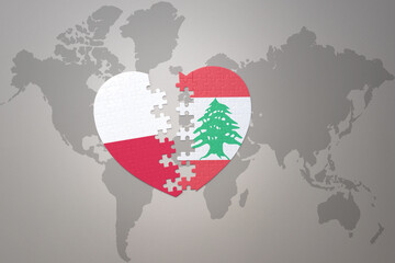 puzzle heart with the national flag of lebanon and poland on a world map background.Concept.
