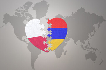 puzzle heart with the national flag of armenia and poland on a world map background.Concept.