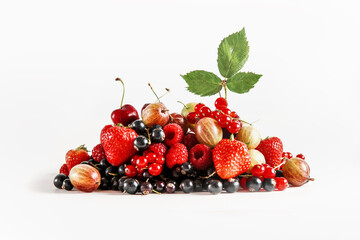 Heap of various summer fruits and berries at white background: currants, strawberries, cherries,...