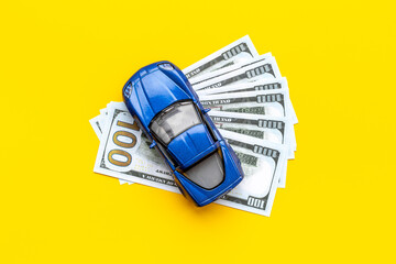 Saving money to buy a car. Toy car with money cash