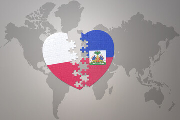 puzzle heart with the national flag of haiti and poland on a world map background.Concept.
