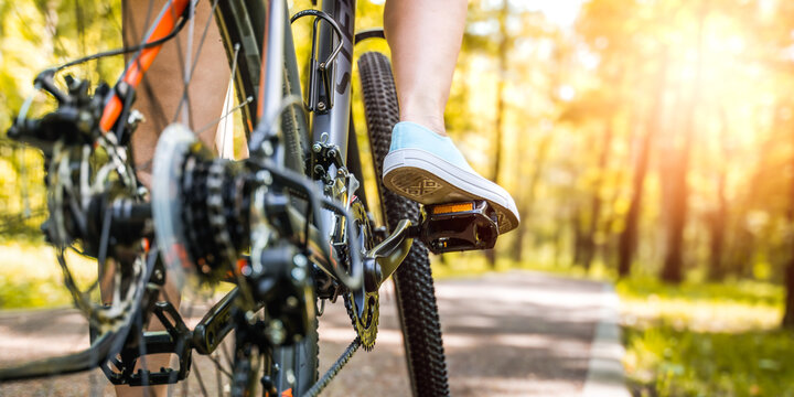 Close up shot of female cyclist. Yellow and orange color tones.