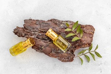 Foto op Plexiglas Arabian oud attar perfume essential oil in glass bottles, top view © 9dreamstudio