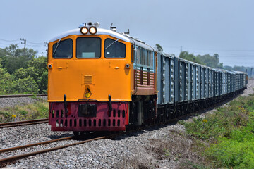Fototapeta premium Freight train by diesel locomotive on the railway in Thailand