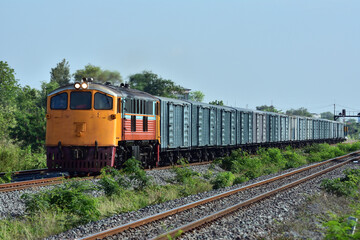 Fototapeta na wymiar Freight train by diesel locomotive on the railway in Thailand