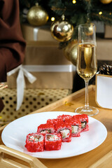 Japanese rolls on New Year's background. Gifts and candles in the background.