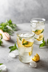 Lemonade or mojito cocktail with lemon and mint, summer cold refreshing drink or beverage with ice