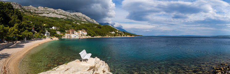 Beautiful panoramic view of Brela Coastline in Dalmatia, Croatia. High Mountains of Biokowo in the background.