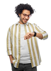 technology and people concept - smiling young man in glasses with smart watch over grey background
