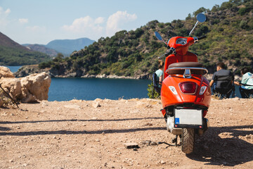 Fototapeta premium Motor scooter on the background of the sea landscape