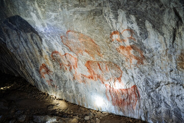 Rock paintings in the cave, ancient people painted on the walls of an underground dwelling, pictures of a caveman, a find of the century.