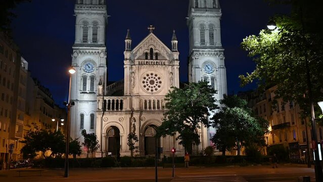 Paris, France, June 2022. Night footage of the Saint-Ambroise church. Tilt movement, beautiful summer evening.