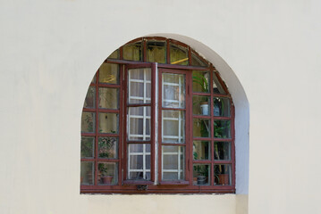 Old arched window with two sashes with facade