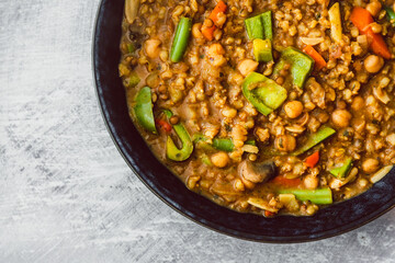 healthy plant-based food, vegan barley and lentil dahl with bell peppers,