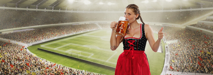 Adorable smiling woman, waitress wearing a traditional Bavarian or german dirndl holding big mug of...