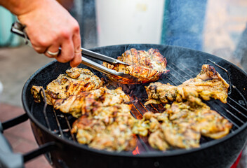 man chef cooking chicken meat on grill outdoor