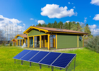 Solar panels. Houses with their own energy source. Panels for generating electricity on lawn. Solar...