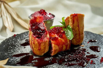 Cherry strudel on slate. Hard light. Selective focus. Close-up
