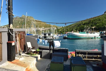 Foto auf Leinwand A big fishing vessel moored in Hout Bay harbor to replenish stock and have a washday © Gerrit Rautenbach