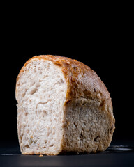 Fresh whole wheat bread with a coffee mug on black background. Healthy eating breakfast.
