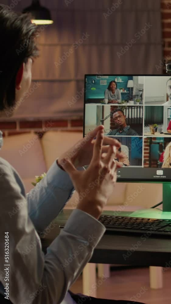 Poster vertical video: office worker using online videoconference call on computer to talk to business coll