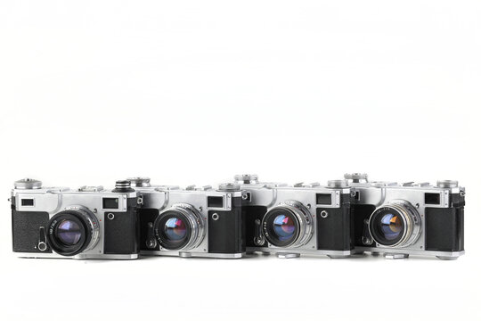 Old vintage rangefinder film cameras on white background.