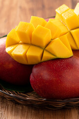 Mango. Fresh mango fruit with leaves over dark wooden table background.