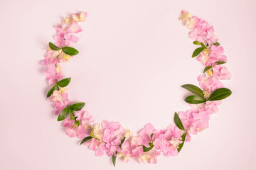 Floral wreath of hydrangea flowers on a pink background. Top view, flat lay. copy space.