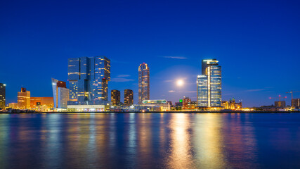 Obraz na płótnie Canvas Rotterdam, Netherlands. View of the city center. Cove and pier for boats and ships. Panoramic view. Cityscape in the evening. Skyscrapers and buildings.