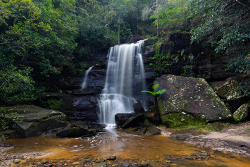 Fototapeta na wymiar Rocky cascade waterfall in the rainforest.