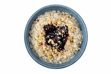 Tasty oatmeal with jam in bowl on white background.