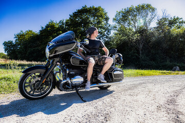 Fototapeta na wymiar Mid aged man sitting on big motorcycle