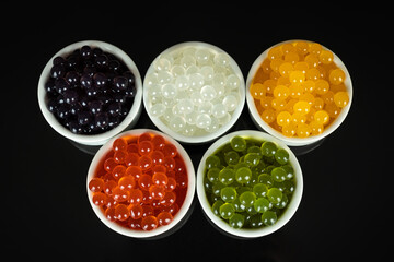 Obraz na płótnie Canvas Different tapioca pearls for bubble tea. Bubble tea ingredients arrangement in bowls