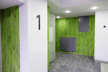New stylish repairs in the entrance of the apartment near the elevators