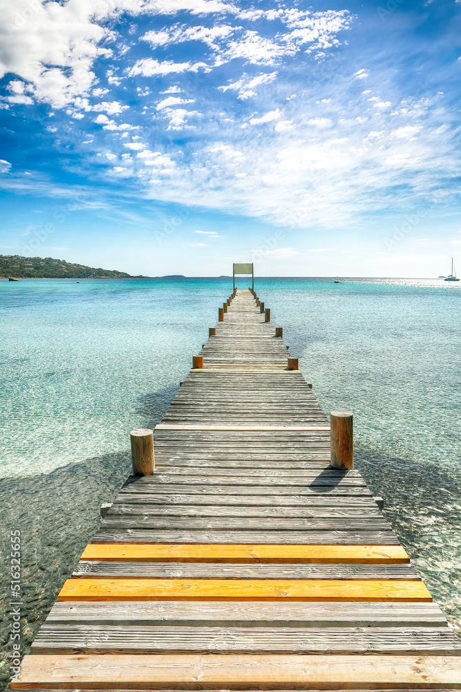 Wall mural Amazing landscape with wooden pier on Santa Giulia beach.