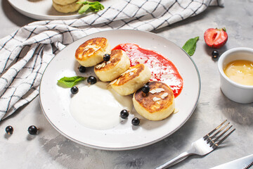 Cottage cheese pancakes, ricotta fritters or syrniki with currant. Healthy and delicious breakfast.
