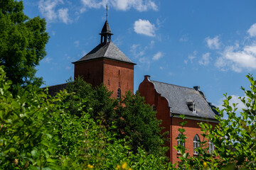 red water castle with trees in foreground